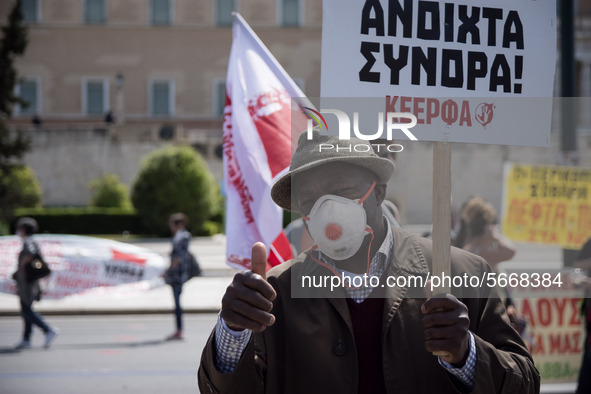 People wearing mask protest on International Worker's Day during the curfew due to Coronavirus (Covid-19) pandemic in Athens, Greece on May...