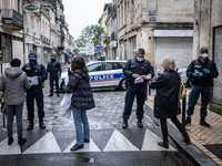 Police check people demonstrating for May Day in Bordeaux, France, on May 1, 2020 during lockdown. (