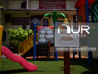 An empty playground with sign temporarily out of service in the school due coronavirus outbreak during the semester off at Wat Mahannapharam...