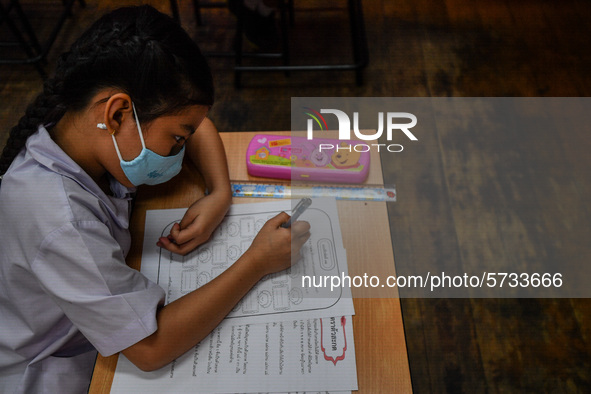 A elementary school student wears a face mask as a preventive measure in a class is a demonstration of learning amid the pandemic of the cor...