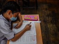 A elementary school student wears a face mask as a preventive measure in a class is a demonstration of learning amid the pandemic of the cor...