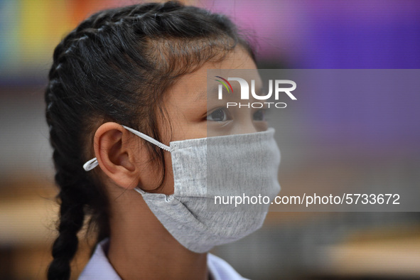 A elementary school student wears a face mask as a preventive measure in a class is a demonstration of learning amid the pandemic of the cor...