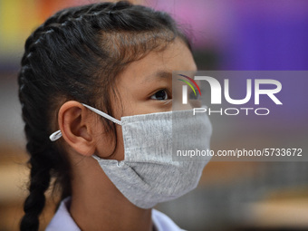 A elementary school student wears a face mask as a preventive measure in a class is a demonstration of learning amid the pandemic of the cor...