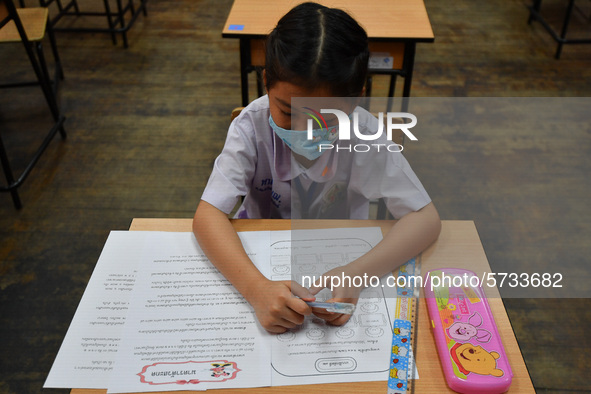 A elementary school student wears a face mask as a preventive measure in a class is a demonstration of learning amid the pandemic of the cor...