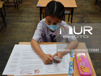 A elementary school student wears a face mask as a preventive measure in a class is a demonstration of learning amid the pandemic of the cor...