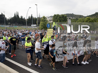 Employees from NISSAN and subcontractors fill a Renault dealership with signs and cut off the access motorway to Barcelona protest in Barcel...