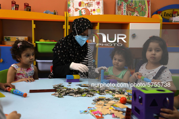 Palestinian children are pictured in a nursery school as it reopens after Palestinians ease the coronavirus disease (COVID-19) restrictions,...