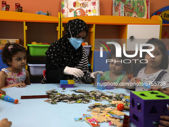 Palestinian children are pictured in a nursery school as it reopens after Palestinians ease the coronavirus disease (COVID-19) restrictions,...