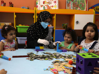 Palestinian children are pictured in a nursery school as it reopens after Palestinians ease the coronavirus disease (COVID-19) restrictions,...