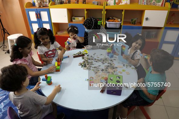 Palestinian children are pictured in a nursery school as it reopens after Palestinians ease the coronavirus disease (COVID-19) restrictions,...