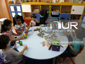 Palestinian children are pictured in a nursery school as it reopens after Palestinians ease the coronavirus disease (COVID-19) restrictions,...