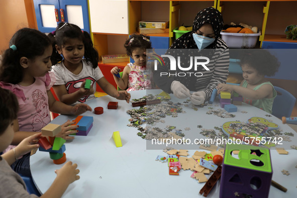 Palestinian children are pictured in a nursery school as it reopens after Palestinians ease the coronavirus disease (COVID-19) restrictions,...