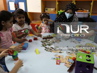 Palestinian children are pictured in a nursery school as it reopens after Palestinians ease the coronavirus disease (COVID-19) restrictions,...