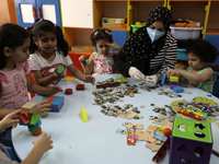 Palestinian children are pictured in a nursery school as it reopens after Palestinians ease the coronavirus disease (COVID-19) restrictions,...