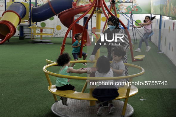 Palestinian children are pictured in a nursery school as it reopens after Palestinians ease the coronavirus disease (COVID-19) restrictions,...