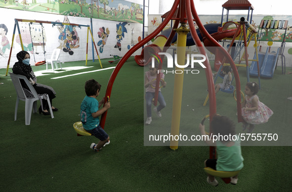 Palestinian children are pictured in a nursery school as it reopens after Palestinians ease the coronavirus disease (COVID-19) restrictions,...