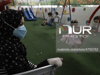 Palestinian children are pictured in a nursery school as it reopens after Palestinians ease the coronavirus disease (COVID-19) restrictions,...