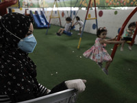 Palestinian children are pictured in a nursery school as it reopens after Palestinians ease the coronavirus disease (COVID-19) restrictions,...