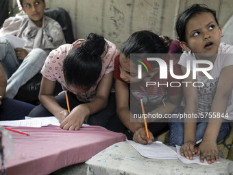 Children attend an Arabic language lesson given by a Palestinian school girl Fajr Hmaid, 13, as schools are shut due to the coronavirus dise...