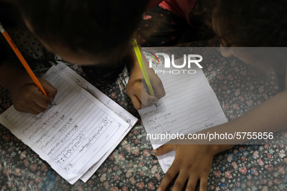 Children attend an Arabic language lesson given by a Palestinian school girl Fajr Hmaid, 13, as schools are shut due to the coronavirus dise...