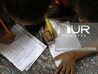 Children attend an Arabic language lesson given by a Palestinian school girl Fajr Hmaid, 13, as schools are shut due to the coronavirus dise...