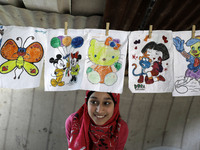 A Palestinian school girl Fajr Hmaid, 13, teaches her neighbours' children an Arabic language lesson as schools are shut due to the coronavi...