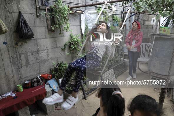 A Palestinian school girl Fajr Hmaid, 13, teaches her neighbours' children an Arabic language lesson as schools are shut due to the coronavi...