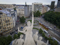 A sculpture on top of the main building of the Warsaw University of Technology, the Gmach Główny Politechniki Warszawskiej
is seen overlooki...