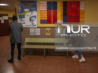 Two students disinfect their hands before entering the classroom in Norena, Spain, on June 8, 2020. The use of masks, disinfectant gels and...