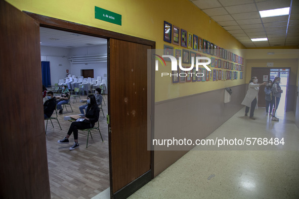 Students in a classroom in Norena, Spain, on June 8, 2020 wait for their teacher's instructions while in the hallway a teacher shows the cla...