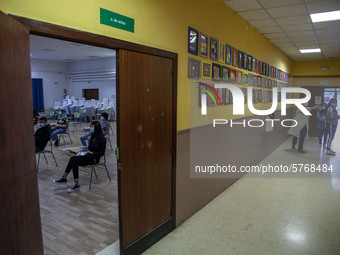 Students in a classroom in Norena, Spain, on June 8, 2020 wait for their teacher's instructions while in the hallway a teacher shows the cla...