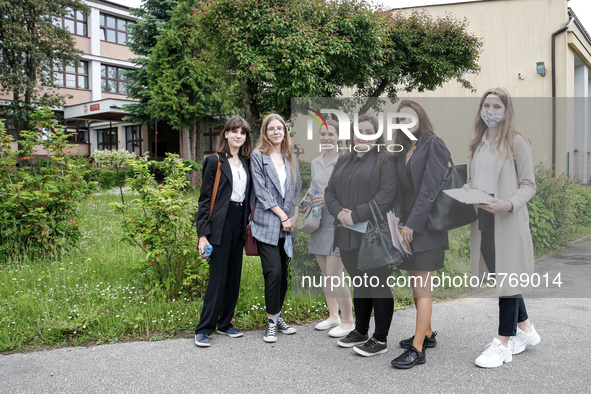 A group of young adults pose to be photographed before taking final graduation exam, called maturity exams in the First General Education Hi...