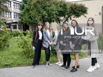 A group of young adults pose to be photographed before taking final graduation exam, called maturity exams in the First General Education Hi...