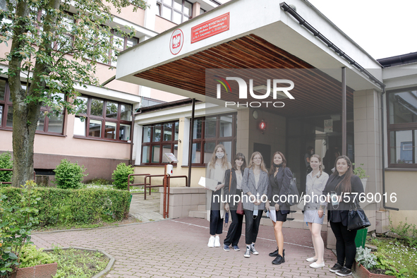 A group of young adults pose to be photographed before taking final graduation exam, called maturity exams in the First General Education Hi...