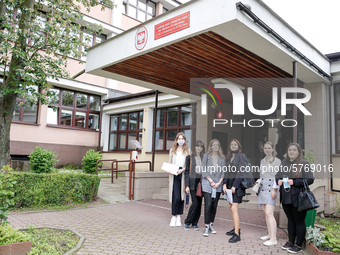 A group of young adults pose to be photographed before taking final graduation exam, called maturity exams in the First General Education Hi...