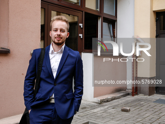 A young adult poses to be photographed before taking final graduation exams, called maturity exams in the First General Education High Schoo...