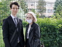 A couple of young adults pose to be photographed before taking final graduation exams, called maturity exams in the First General Education...