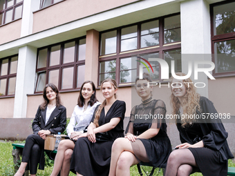 A group of young adults pose to be photographed before taking final graduation exams, called maturity exams in the First General Education H...