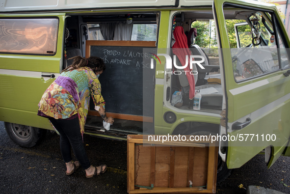 Giulia Zaffagnini, teacher, fixes the desk she uses during her itinerant lessons. On board of a 1970s van she goes under the house of studen...