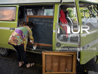 Giulia Zaffagnini, teacher, fixes the desk she uses during her itinerant lessons. On board of a 1970s van she goes under the house of studen...