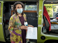 Giuglia Zaffagnini, an Italian teacher, shows the document with which her school director authorized the itinerant lessons. Giulia, on board...