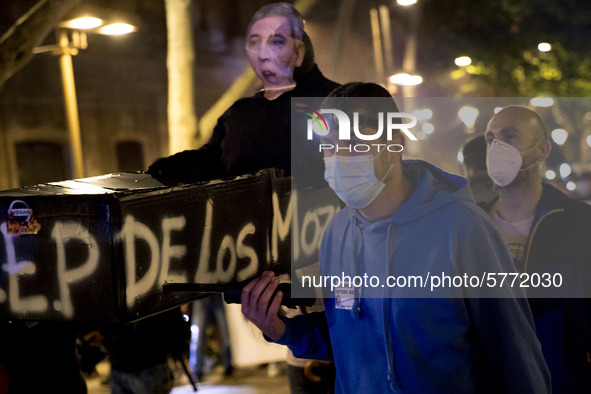 A Nissan employee wearing a face makes takes part in a protest against the closure of the Japanese carmaker's plant in Barcelona on June 9,...