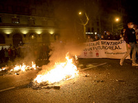 Nissan employees burn mock coffins while holding a banner reading ''Stop lies, we demand a real future'' during a protest against the closur...