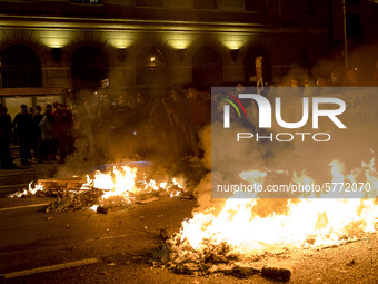 Nissan employees burn mock coffins while holding a banner reading ''Stop lies, we demand a real future'' during a protest against the closur...