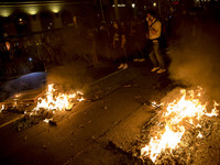 Nissan employees burn mock coffins while holding a banner reading ''Stop lies, we demand a real future'' during a protest against the closur...