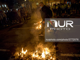 Nissan employees burn mock coffins while holding a banner reading ''Stop lies, we demand a real future'' during a protest against the closur...