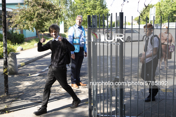   Year 10 pupils enter the gate. Ortu Gable Hall School in Corringham, Essex return after a long break due to the COVID-19 pandemic on Tuesd...