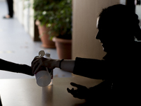   Year 10 pupils getting their hands sanitized by a teacher . Ortu Gable Hall School in Corringham, Essex return after a long break due to t...