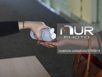   Year 10 pupils get their hand sanitized by a teacher. Ortu Gable Hall School in Corringham, Essex return after a long break due to the COV...