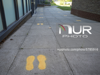   footprints on the ground to indicate where pupils should walk. Ortu Gable Hall School in Corringham, Essex return after a long break due t...